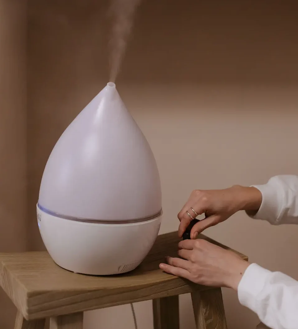 woman prepares humidifer in bedroom
